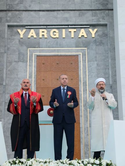President Tayyip Erdogan and Head of Turkey's Directorate of Religious Affairs Ali Erbas pray as they stand next to the President of Court of Cassation Mehmet Akarca during the opening ceremony of a top judicial court building in Ankara, Turkey, September 1, 2021
