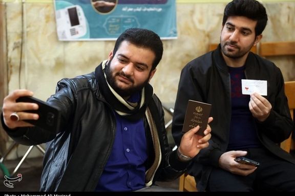 Two Iranians taking a selfie after voting in elections on March 1, 2024