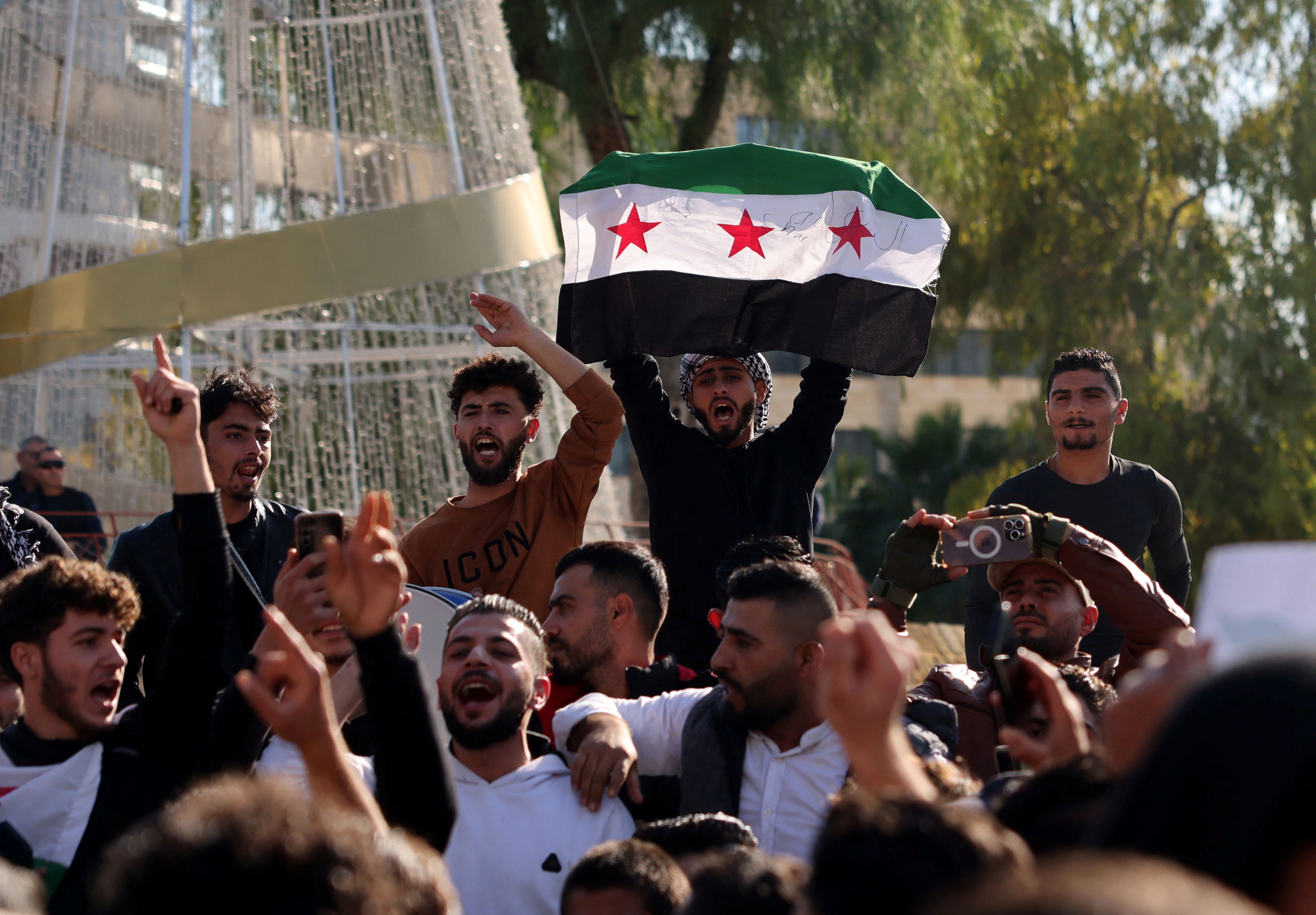 Members of the Syrian community in Cyprus celebrate, after Syrian rebels announced that they have ousted President Bashar al-Assad in Nicosia, Cyprus, December 8, 2024. 