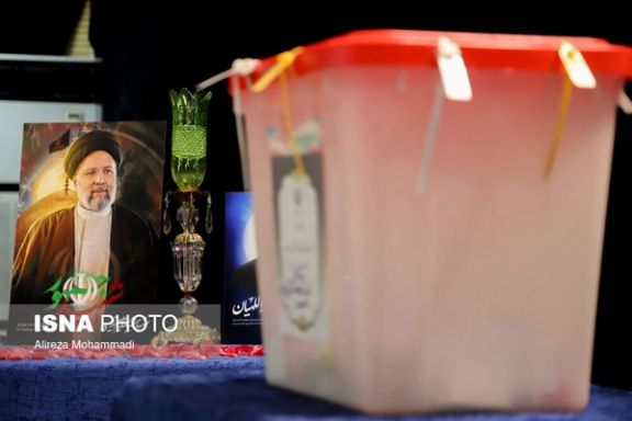 A ballot box next to late president Ebrahim Raisi's picture