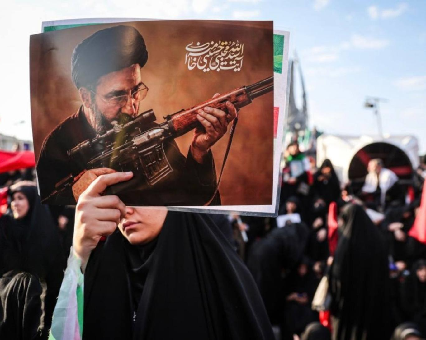 An Islamic Republic supporter holds a photo of Supreme Leader Mojtaba Khamenei during a state-run rally. / Photo by IRNA