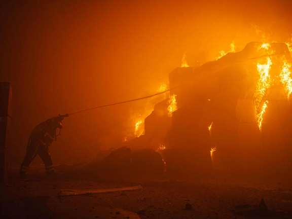 A firefighter in Kyiv trying to put out a blaze after a Russian attack by Iranian drones. May 28, 2023