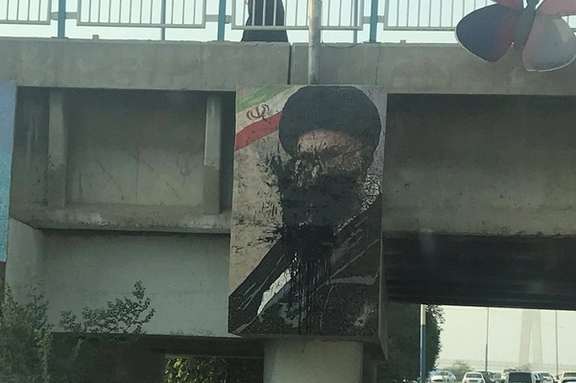 Protesters have thrown black paint at a large banner of Iran's ruler Ali Khamenei. Photo dated October 24, 2022