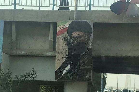 Protesters have thrown black paint at a large banner of Iran's ruler Ali Khamenei. Photo dated October 24, 2022