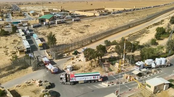 Trucks carrying humanitarian aid to Gaza during a temporary truce between Israel and Palestinian Islamist group Hamas at the Border of Nitzana Crossing on November 26, 2023