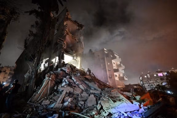 Rescue personel work at a residential building following missile attack from Iran on Israel, at central Israel June 15, 2025.