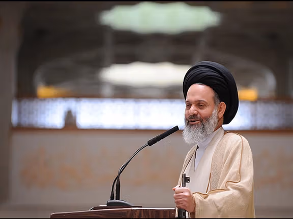 Ayatollah Hashemi Bushehri, holding a gun during a Friday sermon, as is customary for Islamic Republic.