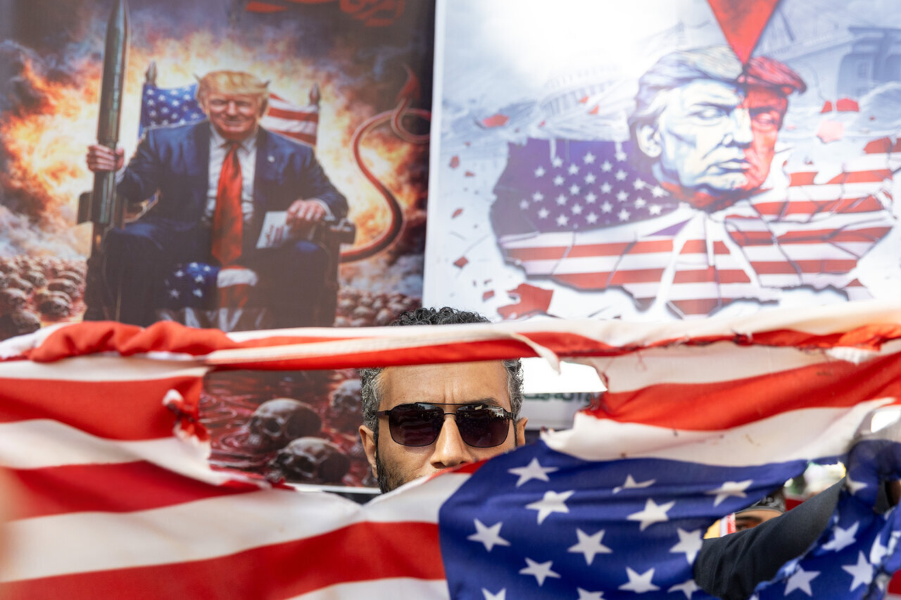 Photos of a torn US flag and President Donald Trump during a state-organized anti-US rally in Tehran.