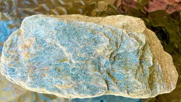 The photo shows a piece of natural lithium