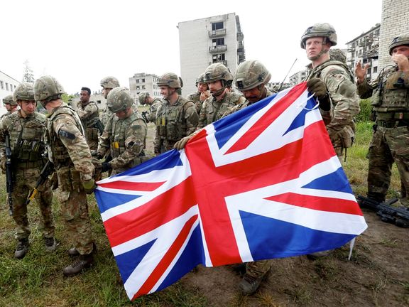 British Royal Marines servicemen hold Union Jack after the UK-led Joint Expeditionary Force (JEF) military exercise Baltic Protector 2019 in the former Soviet military town near Skrunda, Latvia July 2, 2019.