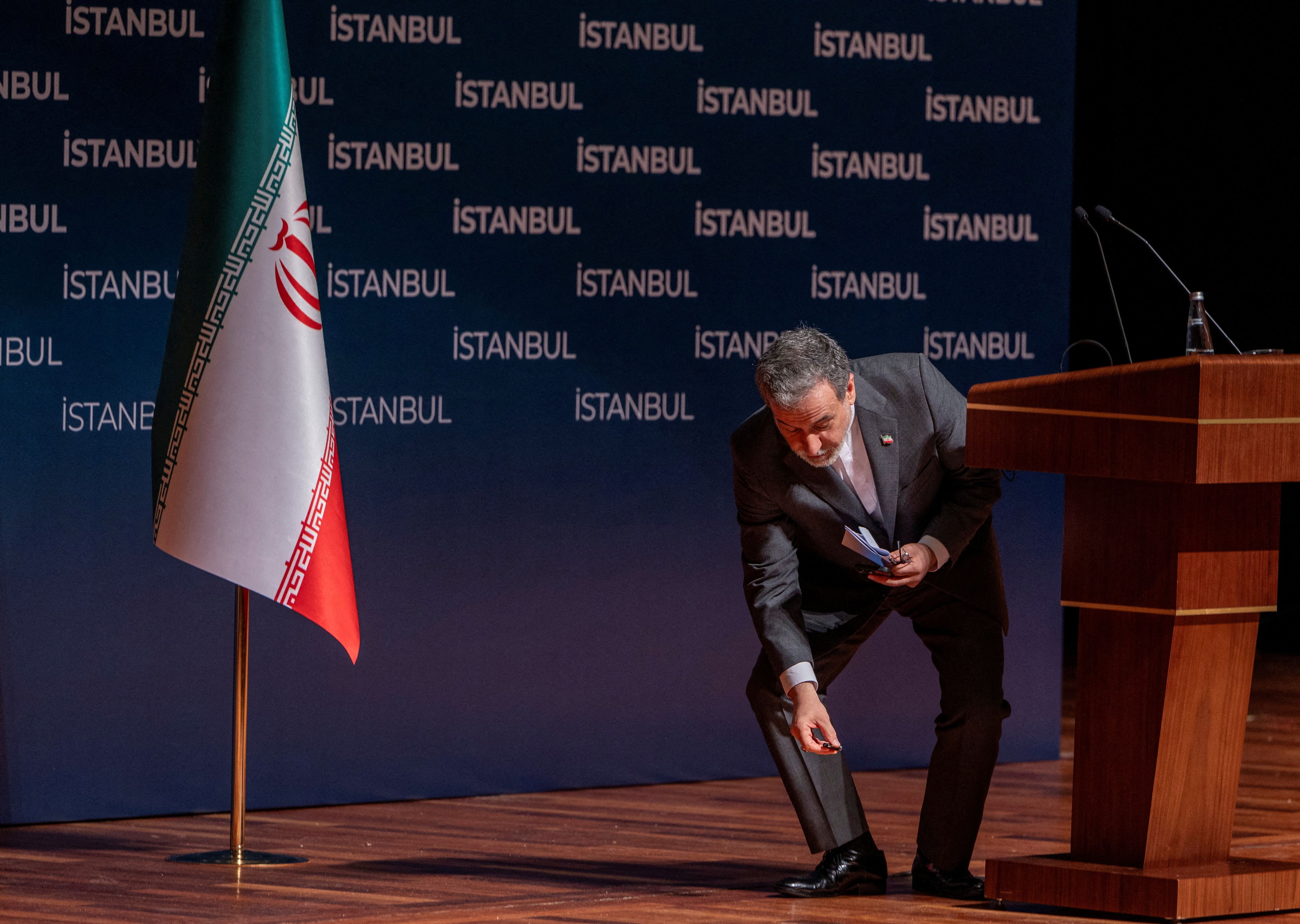 Iranian Foreign Minister Abbas Araqhchi leans to pick up a dropped thing after a press conference in Istanbul, Turkey, June 22, 2025. 