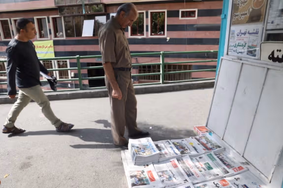 An Iranian man looks at a newspaper with a picture of Iran's presidential election in Tehran, Iran June 29, 2024.