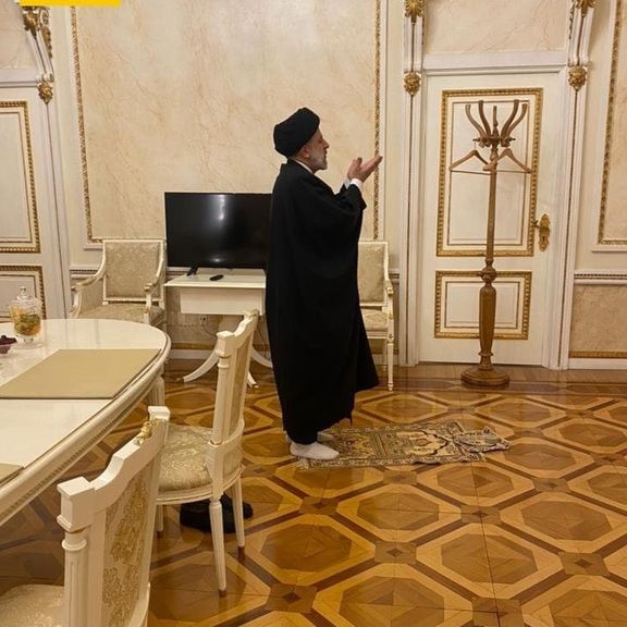 Iran's President Ebrahim Raisi praying in the Kremlin on January 19, 2022