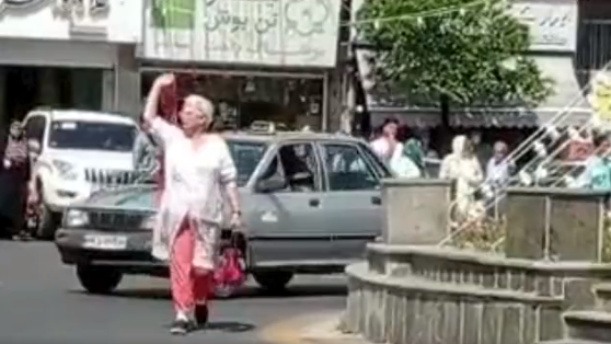 A frame of the video of a woman who removed hijab in public in northern Iran