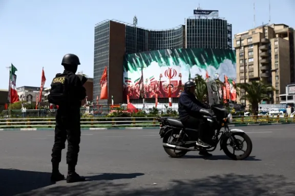 A member of a police force stands guard on a street in Tehran, Iran, on April 1, 2026.