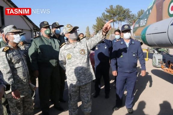 Photo published by Tasnim news agency showing Iranian officers looking at a Sukhoi 24 warplane allegedly fitted with a cruise missile.