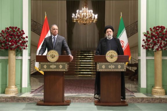 Iraqi Prime Minister Mustafa al-Kadhimi (left) and Iranian President Ebrahim Raisi during a joint press conference in Tehran on June 26