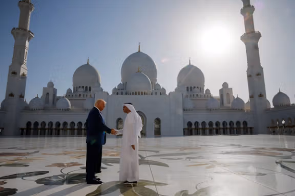 President Donald Trump shakes hands with Yousif Al Obaidli, director of Sheikh Zayed Grand Mosque, as he tours the mosque grounds in Abu Dhabi, United Arab Emirates, May 15.