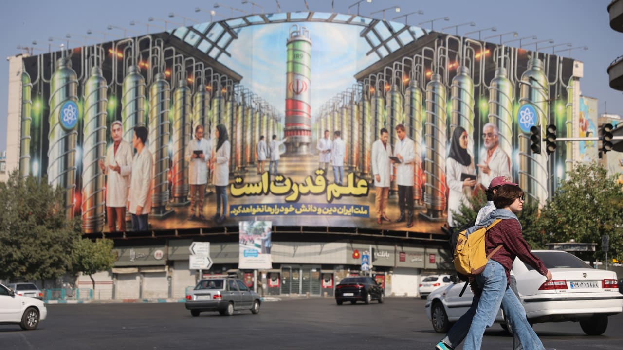 A billboard with Iranian centrifuges illustrations and portraits of nuclear scientists killed in Israeli strikes is displayed on a street in Tehran, Iran August 29, 2025