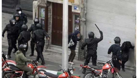 An undated photo showing special police units beating a woman in Iran