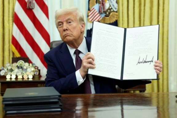 US President Donald Trump signs executive orders in the Oval Office, January 23, 2025.