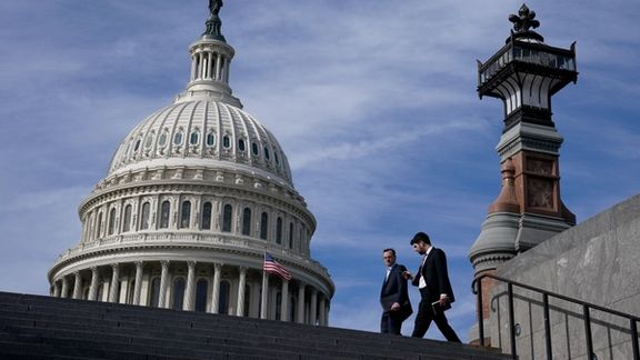 People walk past the US Capitol building in Washington, November 15, 2023.