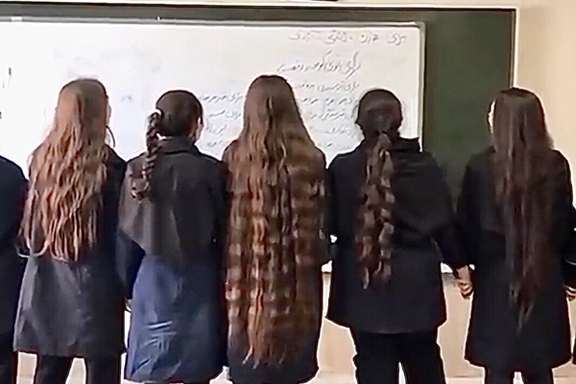 Teenage girls take off their hijab at school, and write revolutionary slogans on the board. October 3, 2022