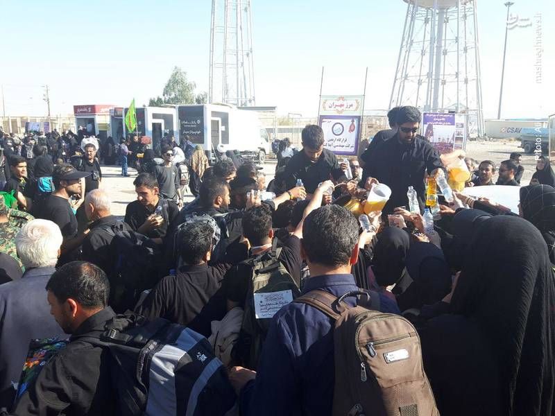 Iranian pilgrims stand in line for water in their way to the to the Iraqi city of Karbala 