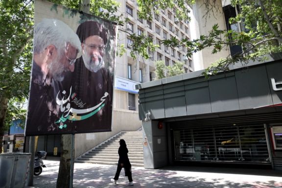 A woman walks near a banner of presidential candidate Saeed Jalili displayed on a street in Tehran, Iran June 27, 2024.