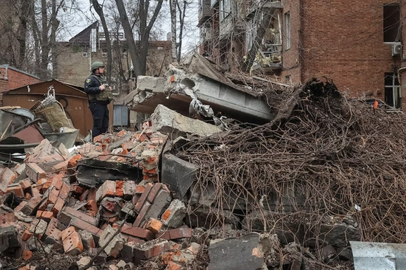 A police officer stands at a site of apartment buildings hit by a Russian missile strike, amid Russia's attack on Ukraine, in Kharkiv, Ukraine November 25, 2024.