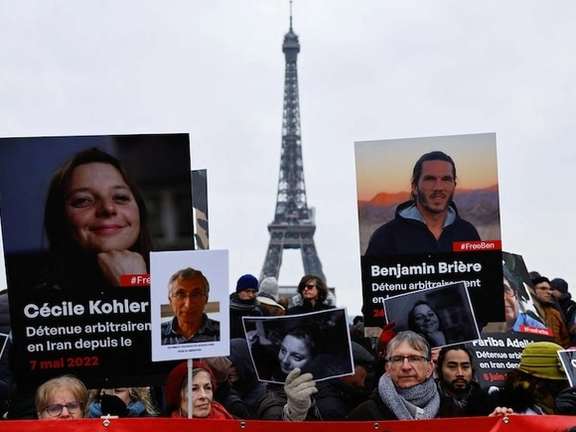Supporters and relatives of French citizens detained in Iran, Cecile Kohler, Benjamin Briere, Jacques Paris and Fariba Adelkhah, gather in front of the Eiffel Tower, during a rally demanding their release, in Paris, France, January 28, 2023.