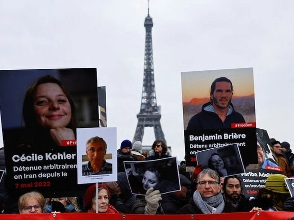 Supporters and relatives of French citizens detained in Iran, Cecile Kohler, Benjamin Briere, Jacques Paris and Fariba Adelkhah, gather in front of the Eiffel Tower, during a rally demanding their release, in Paris, France, January 28, 2023.