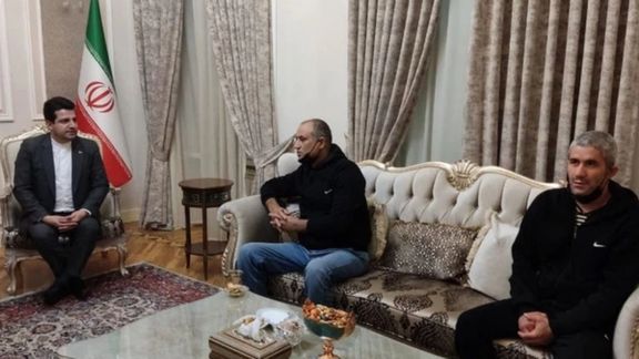Two Iranian truck drivers seen (C) and (R) in this photo were released by Azerbaijan. October 21, 2021