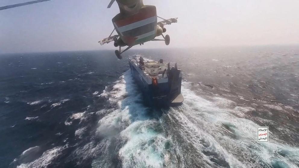 Houthi military helicopter flies over the Galaxy Leader cargo ship in the Red Sea in this photo released November 20, 2023.