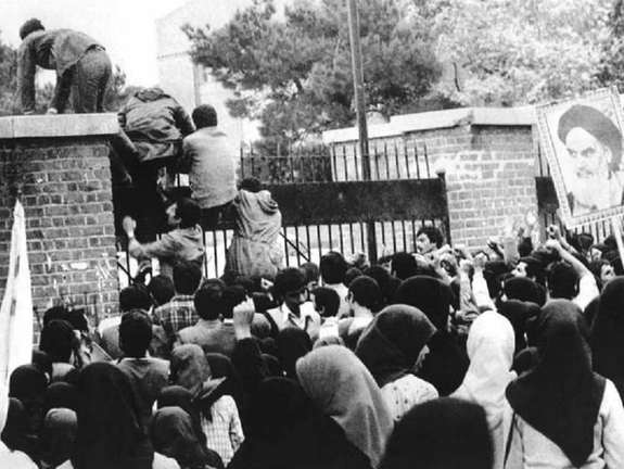 Iranian students climb up US embassy gates in Tehran