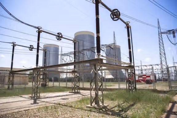 Cooling towers and electrical transmission equipment are seen at the Rajaee power plant in Qazvin, Iran, on April 25, 2025.