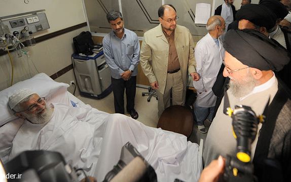 Ayatollah Kazem Nourmfidi, the representative of the Supreme Leader in the northern Golestan province visiting Supreme Leader Ali Khamenei (left) at hospital in 2014