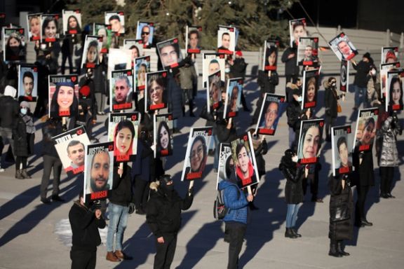 People hold placards with images of the victims of the downing of Ukraine International Airlines flight PS752 in a march to mark its first anniversary, in Toronto, Ontario, Canada January 8, 2021.