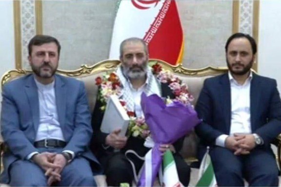 Assadollah Assadi (center) received a hero's welcome by government spokesman Ali Bahadori Jahromi (right) and Kazem Gharibabadi, the deputy head of the Judiciary who is also secretary of the High Council for Human Rights as well as several other officials.