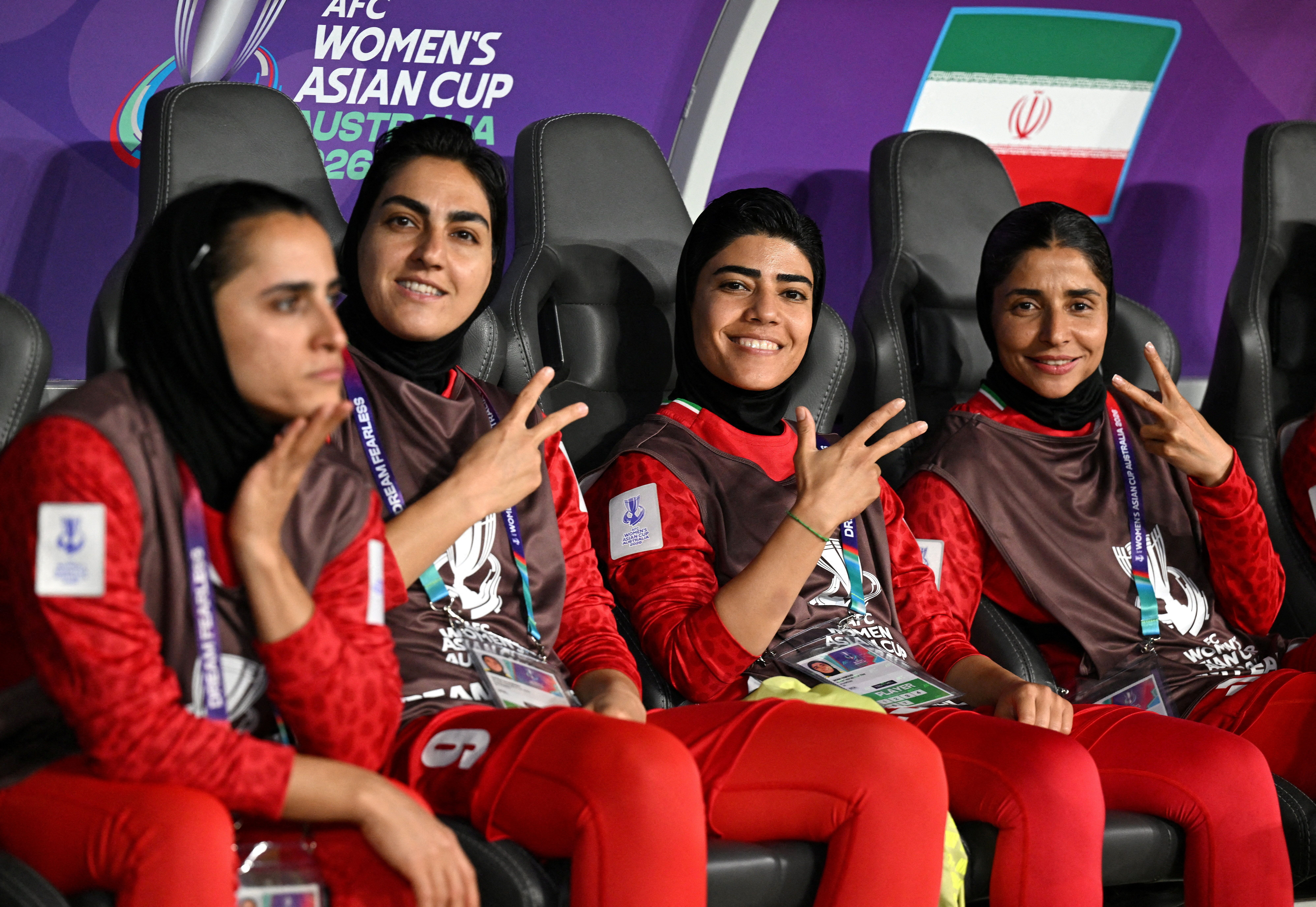 Iran players Zahra Ghanbari (left), Mona Hamoudi and Atefeh Ramezanizadeh react from the bench during the AFC Women’s Asian Cup Group A match between Iran and the Philippines at Gold Coast Stadium in Australia on March 8, 2026.