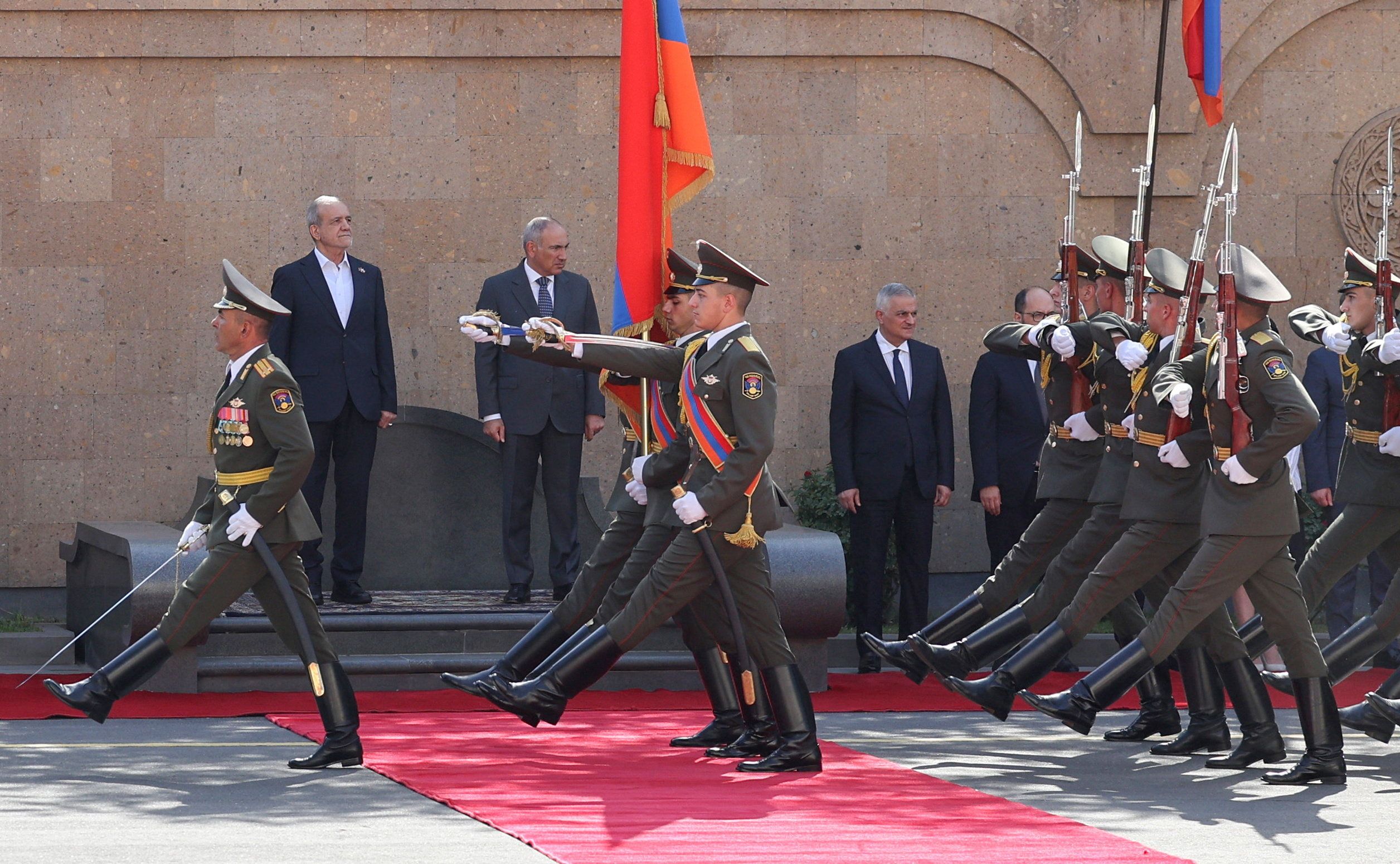 Guards of honour march past officials, including Armenian Prime Minister Nikol Pashinyan and Iranian President Masoud Pezeshkian, during a welcoming ceremony before talks in Yerevan, Armenia, August 19, 2025. 