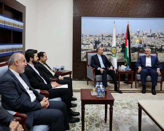 Iranian Foreign Minister Hossein Amir-Abdollahian (center) during a meeting with Hamas's political leader Ismail Haniyeh (left) in Doha on December 19, 2023