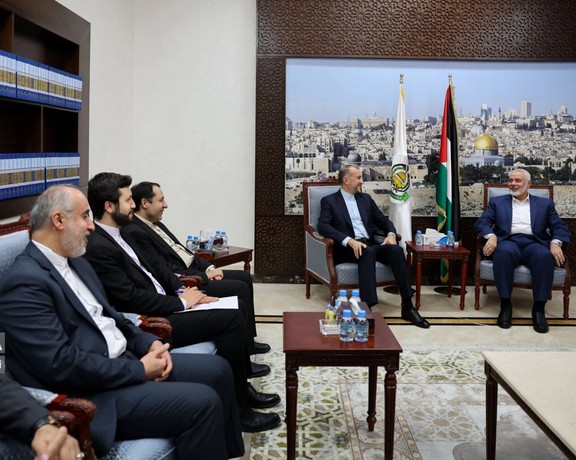 Iranian Foreign Minister Hossein Amir-Abdollahian (center) during a meeting with Hamas's political leader Ismail Haniyeh (left) in Doha on December 19, 2023