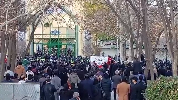 The people gathering outside a mosque in Mashhad where a memorial service was held for Iranian rights lawyer Khosrow Alikordi on December 12, 2025