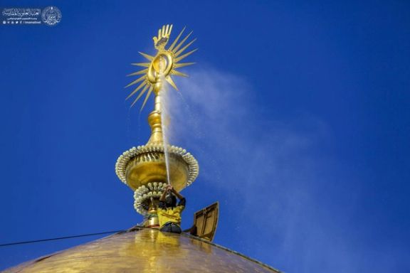 An Iranian worker is washing the dome of the shrine of first Shiite Imam Ali ibn Abi Ṭalib in February 2022.