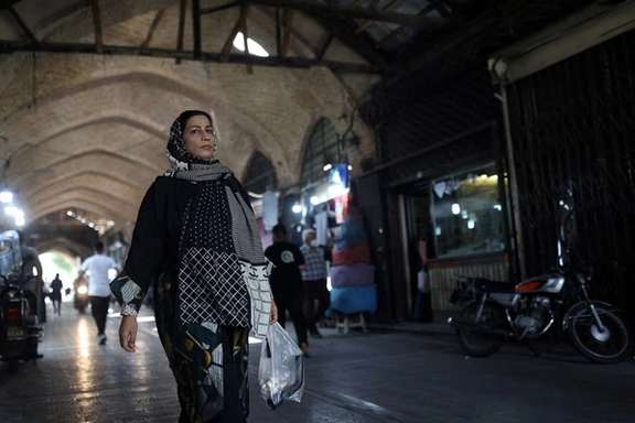 An Iranian woman walks in a market in Tehran, Iran May 1, 2022.