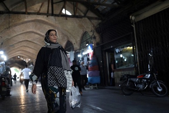 An Iranian woman walks in a market in Tehran, Iran May 1, 2022.