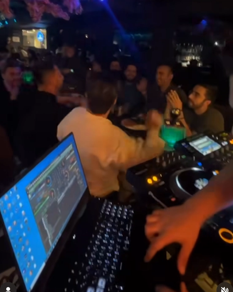 A DJ performs in a night club in Iran