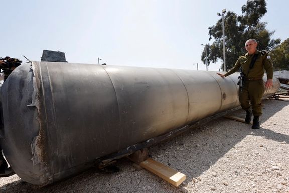Israeli military spokesperson Rear Admiral Daniel Hagari stands as Israel's military displays what they say is an Iranian ballistic missile which they retrieved from the Dead Sea after Iran launched drones and missiles towards Israel, at Julis military base, in southern Israel April 16, 2024.