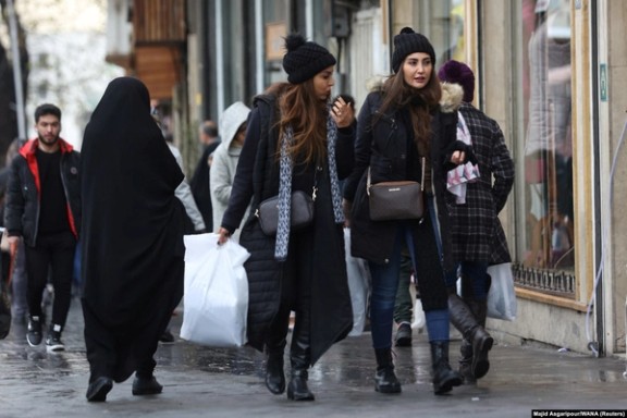 Women walk along a street in Tehran on December 6, 2024.